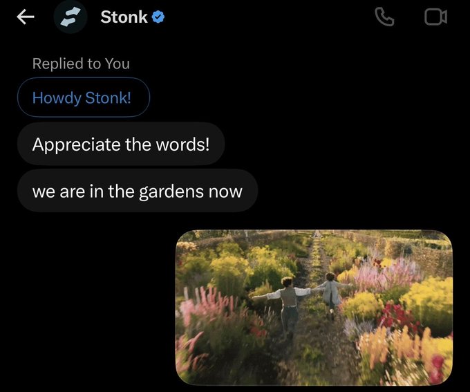 A Twitter/X direct message from Stonk reading 'Howdy Stonk!' and 'Appreciate the words! we are in the gardens now,' accompanied by a photo of two children running through a vibrant flower garden.