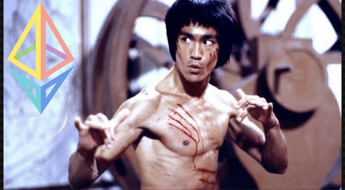 The image features a muscular man with black hair wearing a shirtless tank top, holding a boxing glove and having blood coming out of his arm. The background shows an abstract design that includes a triangle and a circle. The caption for the image reads "I fear not the man who has bought 10,000 coins once I fear the man who has bought one coin 10,000 times It's a beautiful day to buy more $ETH".