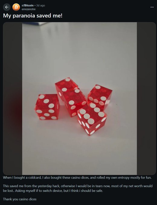 The image shows four red translucent casino dice with white pips displayed on a white surface, shared in r/Bitcoin by user "erezeetre" with the title "My paranoia saved me!" The accompanying text explains that alongside purchasing a coldcard hardware wallet, the user bought the dice to generate their own entropy, which they believe protected their crypto from a recent hack that affected other users.