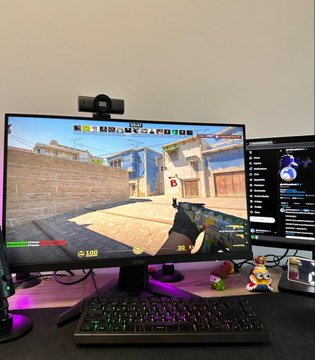 A gaming setup shows a monitor displaying a Counter-Strike match with the scoreboard reading 4-5, alongside a webcam, keyboard, and mouse on a desk with purple ambient lighting—reflecting the poster's dedication to training for a CS tournament on Polymarket with a $2,000 prize pool.