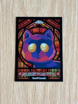 urn of gold and purple liquid with a black cat's face, eyes, nose, and mouth on a red background.