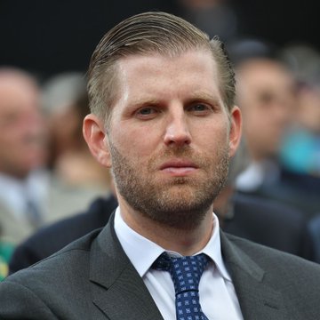 Eric Trump, pictured in a dark suit and patterned tie, has seen over $600 million erased from his family's fortune due to their bitcoin mining investments, according to Bloomberg.