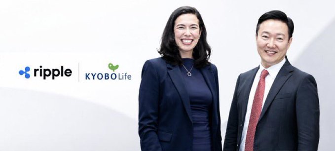 A corporate photo featuring two smiling professionals in business attire alongside the Ripple and Kyobo Life logos, suggesting a partnership announcement.