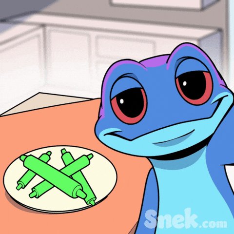 The image features a cartoon frog sitting at a table with food items on top of it, specifically four green pipe cleaners that look like snacks. In the background, there are several kitchen cabinets visible behind the frog. The overall scene depicts a humorous cartoon depiction of a frog enjoying its snack time in a room with kitchen elements nearby.