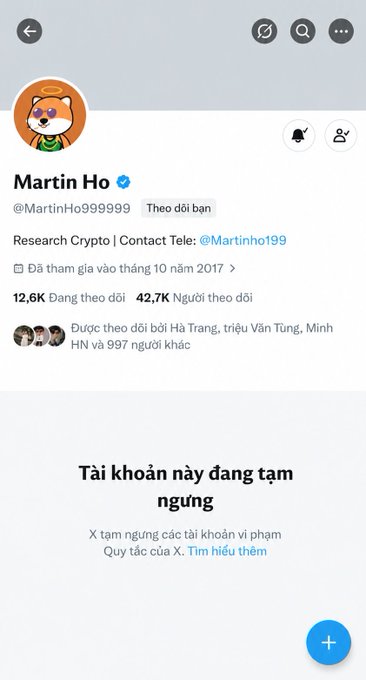 A Twitter/X profile page for 'Martin Ho' (@MartinHo999999) with a dog avatar, bio reading 'Research Crypto | Contact Tele: @Martinho199', 12.6K following and 42.7K followers, showing the account is suspended ('Tài khoản này đang tạm ngưng').