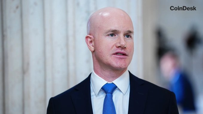 A bald man in a dark suit and blue tie appears in what looks like a professional setting, with the "CoinDesk" logo visible in the upper right corner. The image relates to the post about Coinbase's Brian Armstrong and his discussion on merging AI with crypto technology, branded as "AiFi."