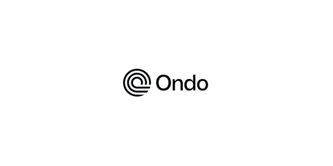 The image displays the Ondo logo, featuring a circular labyrinth-like symbol next to the word "Ondo" in black text on a light gray background, representing the brand behind the newly launched $ONDO perpetual futures markets for trading US stocks, ETFs, and commodities 24/7.
