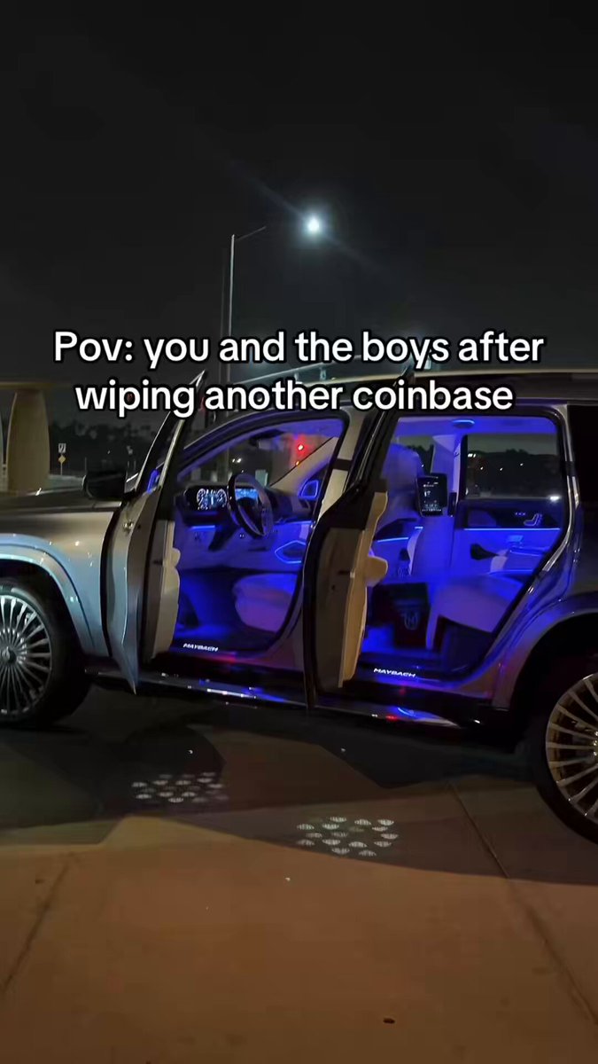 The image shows a silver SUV parked on a street at night, with its doors open. There are two people standing next to the car, possibly discussing something or preparing for an event. The background of the photo features a street lamp that illuminates the scene and adds depth to the image.