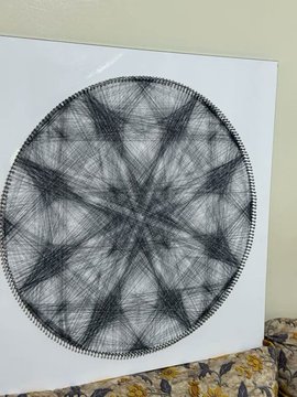 The image features a large, circular piece of artwork made entirely out of strings. The artwork has a black and white color scheme with intricate patterns and designs. It appears to be a unique and creative form of art that captures attention due to its unconventional use of materials. The artwork is displayed on a white surface, which contrasts nicely with the black and white colors used in the piece. The image also includes text that reads "I'll be giving away 2 GTD + 5 FCFS spots for Zelij Origins! The Medium: 1/1 pieces Total Supply: 888 Chain: Ethereum To enter: • Follow me & @ZelijOrigins • Like & Repost • Drop your EVM wallet address winners will be announced in 24 hours." This text suggests that the artwork is part of a contest or promotion related to the Zelij Origins community.