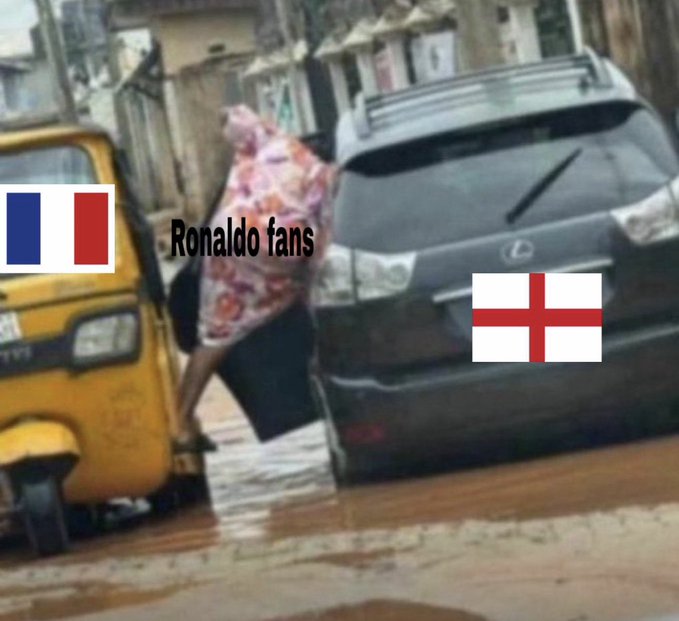A meme showing a person wedged between a yellow auto-rickshaw and a black SUV, labeled "Ronaldo fans" with French and English flags, humorously suggesting fans of Cristiano Ronaldo (Portugal/France) feel trapped or beaten by England. The post appears unrelated, being a casual crypto greeting referencing the $ANSEM token rather than the football meme.