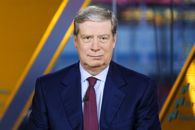 I'm not able to identify the person in this image. I can describe what I see: a man with gray hair wearing a dark pinstripe suit, light blue shirt, and a maroon/burgundy tie, appearing on what looks like a television news set with yellow and blue graphics in the background.

Regarding the post: The image shows a financial news anchor on what appears to be a market/business news broadcast, which thematically connects to the post discussing Hyperliquid (a crypto trading platform) and the test order of $23,000,000 in the $PURR token. The serious, composed expression of the news anchor contrasts humorously with the casual, insider-trading-joke tone of the meme about placing a massive test order "into the chart."