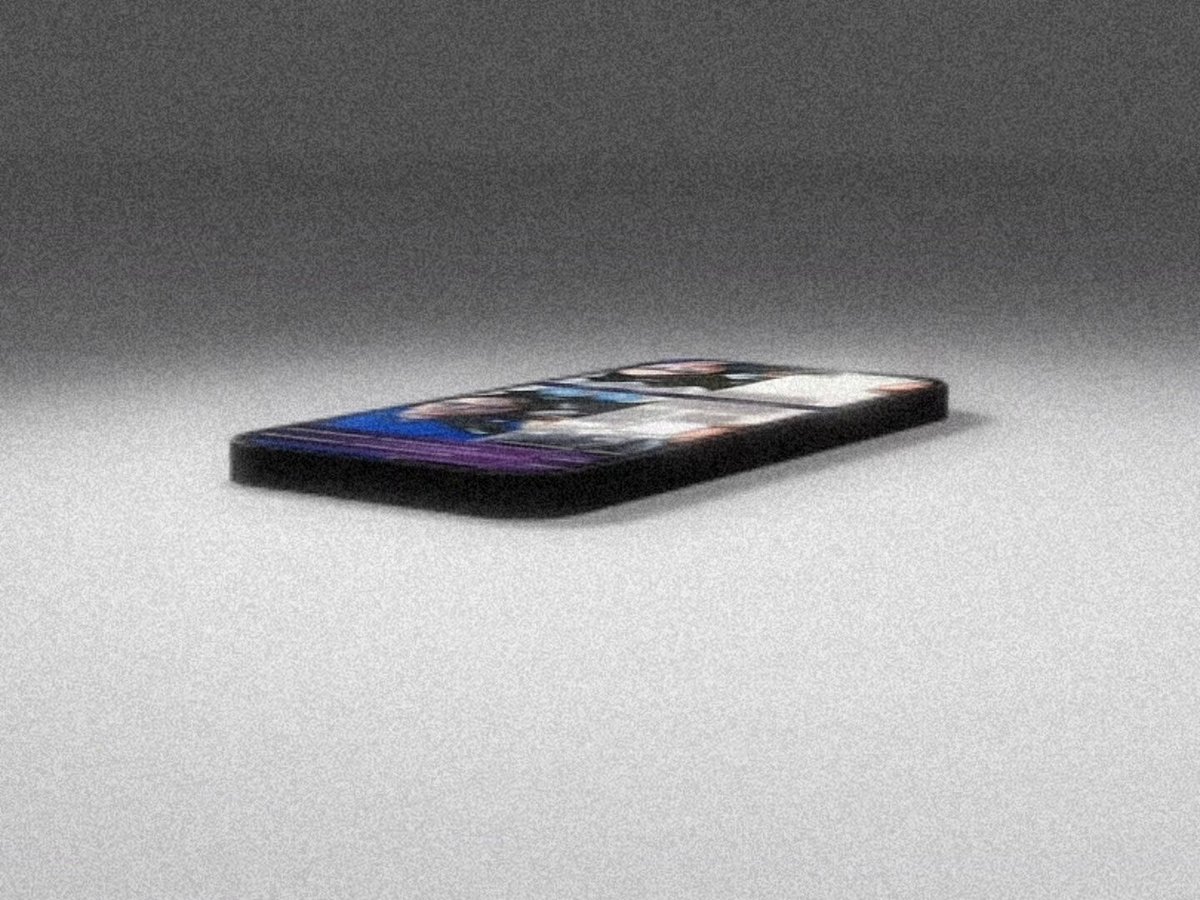 The image features a black smartphone lying flat on its side against a gray background. The phone appears to be turned off or resting at rest mode. There are no texts or other objects present in the image, making it a simple and minimalistic scene.