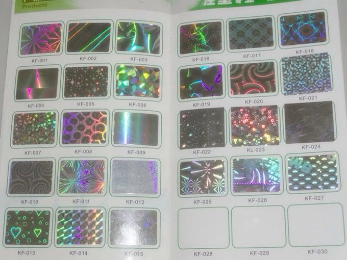 A catalog page displaying various holographic and laser-effect card samples labeled KF-001 through KF-030.