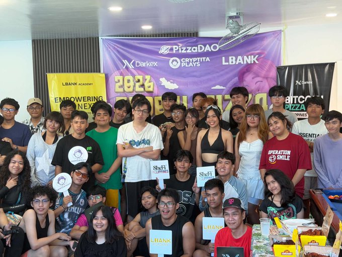 iced tea and snacks are available for sale at a PIZDAO event, with attendees posing for photos on stage.