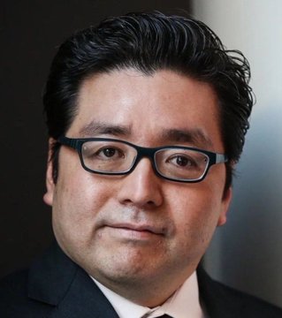 A professional headshot of a man wearing glasses and a suit, presumably Tom Lee, the analyst referenced in the post making a bullish $5,000 year-end price prediction for Ethereum.