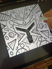 A tablet displaying a black and white abstract line drawing with geometric shapes including triangles, circles, and a prominent angular symbol in the center.