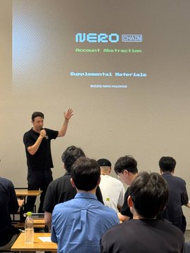 A man presents at a conference with a projected slide titled 'NERO CHAIN Account Abstraction Supplemental Materials' to an audience seated in front of him.