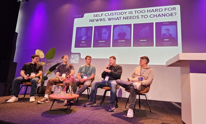 A panel discussion at what appears to be the 'SELF CUSTODY IS TOO HARD FOR NEWBS. WHAT NEEDS TO CHANGE?' event, with five panelists seated on stage and their photos displayed on the screen behind them.