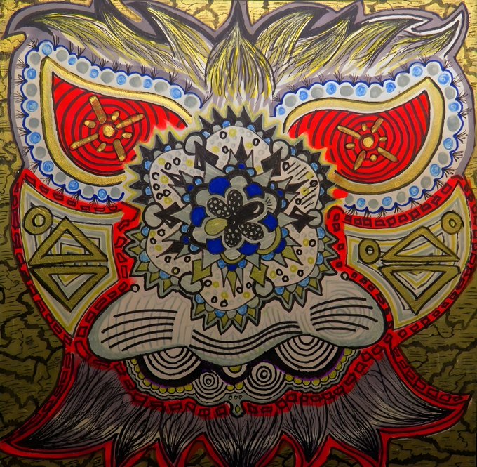 An intricate, colorful artwork depicting a symmetrical stylized face or mask with elaborate patterns, featuring red almond-shaped eyes, a central flower-like motif, and gold textured background.