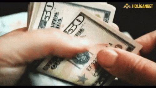 In the image, a person's hand is holding $50 United States Dollar bills. The caption below reads "Big Opportunity Giveaway 25X2 total 50$ USDT To Enter: Follow @btc_mr58354 RT, Like & Comment Ends in 24 hours don't miss out." The context of the image suggests that it might be an advertisement or promotional content related to Bitcoin and cryptocurrency, possibly featuring a prize for winning Bitcoins.