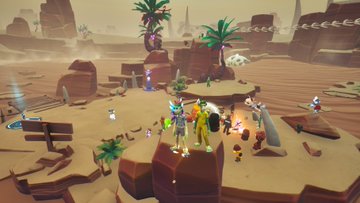 A video game screenshot showing small cartoonish characters gathered on a desert plateau with rocky formations, palm trees, and what appears to be a mech in the background.