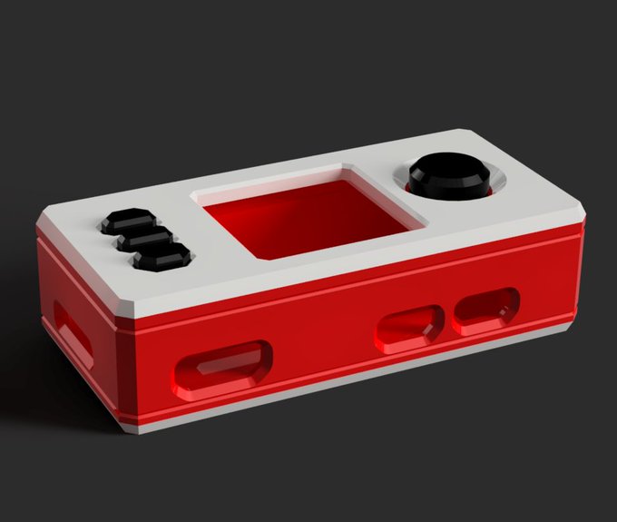 A 3D render of a red and white handheld device resembling a portable gaming console, featuring black directional pads, a joystick, a rectangular screen cutout, and button-shaped indentations on the sides.