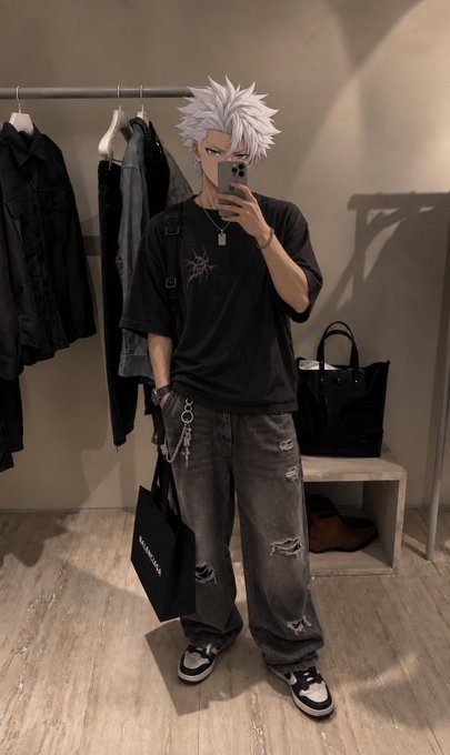 A person with spiky white hair takes a mirror selfie in a clothing store, wearing a black graphic t-shirt, distressed gray jeans, and sneakers, accessorized with a necklace and wallet chain while holding a black shopping bag.