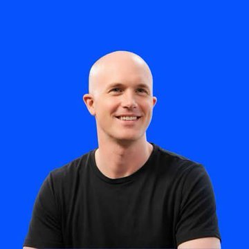 A bald, smiling man in a black T-shirt is pictured against a solid blue background, appearing in a professional headshot style often used for company announcements or executive communications related to Coinbase's newly received UK investment services authorization.