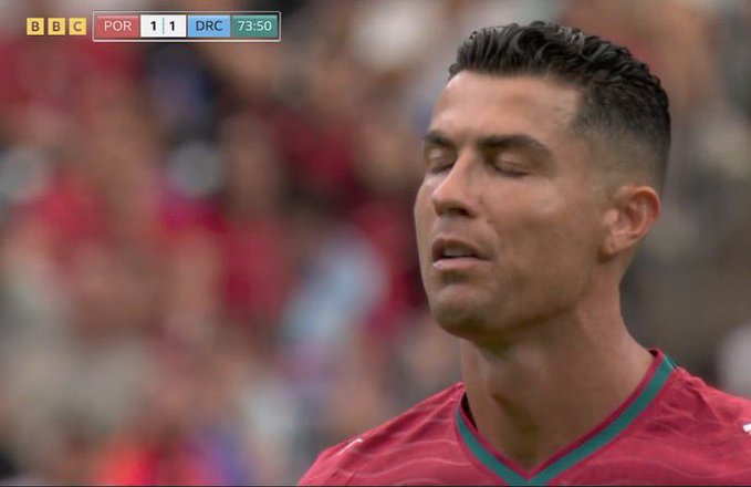 A BBC broadcast screenshot of Cristiano Ronaldo with eyes closed in a Portugal jersey during a match, with the scoreboard showing POR 1-1 DRC at 73:50.