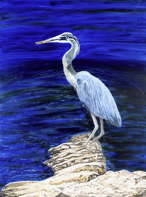 A painted artwork of a blue heron standing on rocks against a vibrant blue water background.