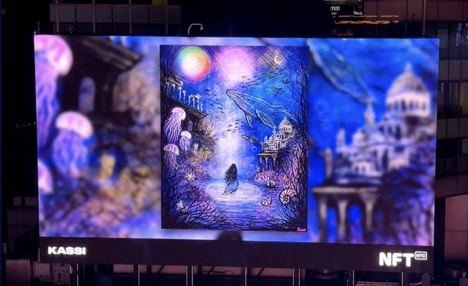 A large outdoor billboard labeled "KASSI NFT TWO" displays an underwater fantasy scene featuring a mermaid, jellyfish, and a sunken city under glowing orbs.