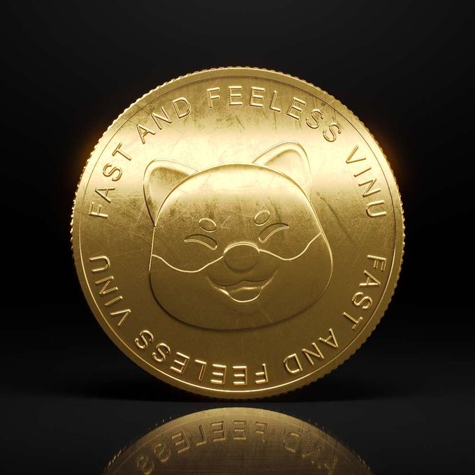 A gold commemorative coin with a smiling cartoon face in the center, encircled by the repeating text 'FAST AND FEELESS' set against a black reflective background.