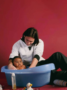 The contrast between the image's intimate, tender scene of a woman bathing a baby with rubber ducks and the post's mention of massive World Cup betting wins creates an ironic juxtaposition between simple, everyday caregiving and the high-stakes world of cryptocurrency sports gambling, highlighting how unrelated visuals can be paired with financial claims to grab attention.