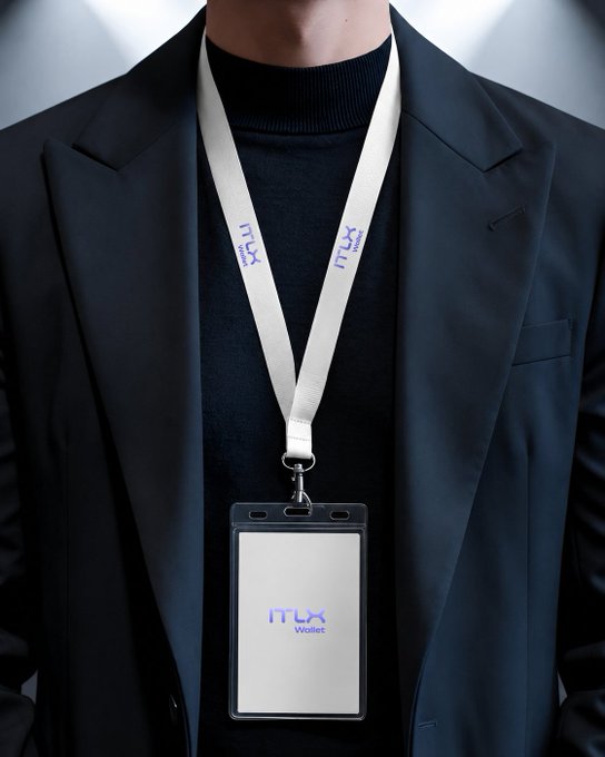 The image shows a person wearing a black blazer with a white lanyard around their neck. The lanyard has a logo that reads "ITLX" and "WILDCARD", indicating that they are part of an IT team or organization. The person is standing against a gray background, which emphasizes the details of the lanyard and their attire.