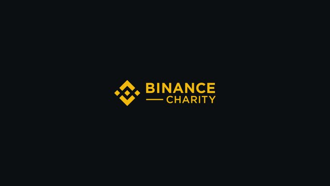 The image displays the Binance Charity logo on a dark background, featuring the distinctive diamond-shaped Binance icon in yellow alongside the "BINANCE CHARITY" text. It connects to the post about praying for Columbia as Binance Charity is known for providing humanitarian aid and disaster relief efforts, likely highlighting their support or response to events affecting the country.