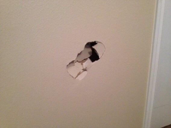 A hole punched through a wall revealing the space behind it, likely symbolizing a breakthrough moment or pending impact in the context of the post about an anticipated retail investment wave on Solana.