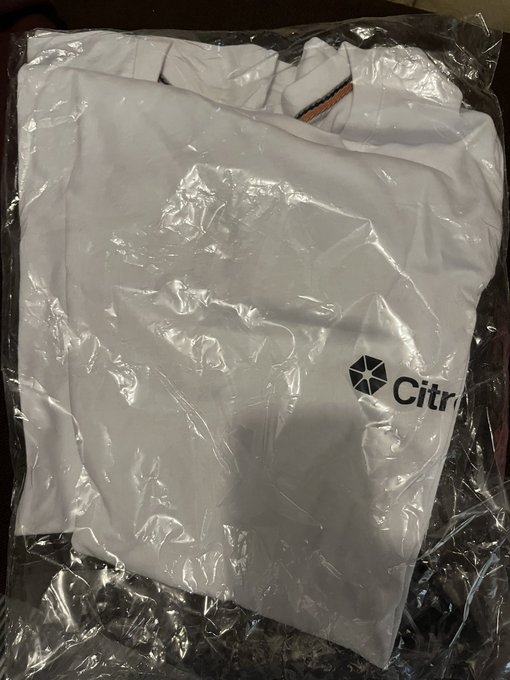 A white Citra-branded garment or hoodie is folded and sealed inside a clear plastic bag, possibly a mystery merchandise item.