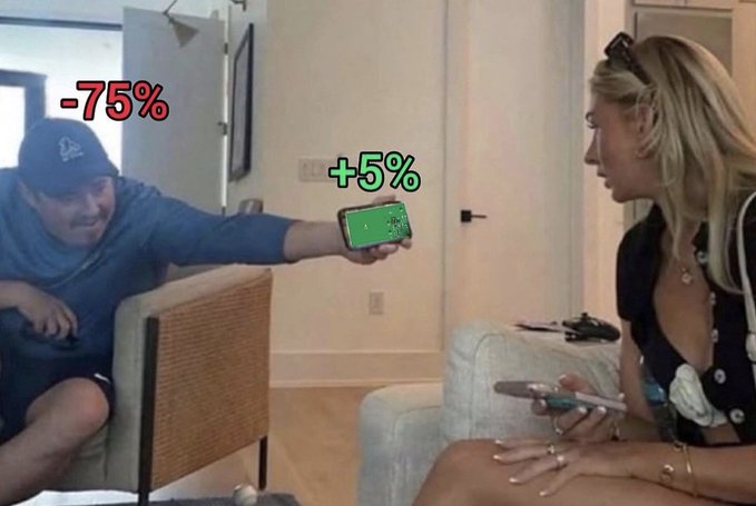 A man shows a woman a phone displaying a stock chart with text overlays reading '-75%' and '+5%', humorously illustrating a dramatic investment loss versus a small gain.