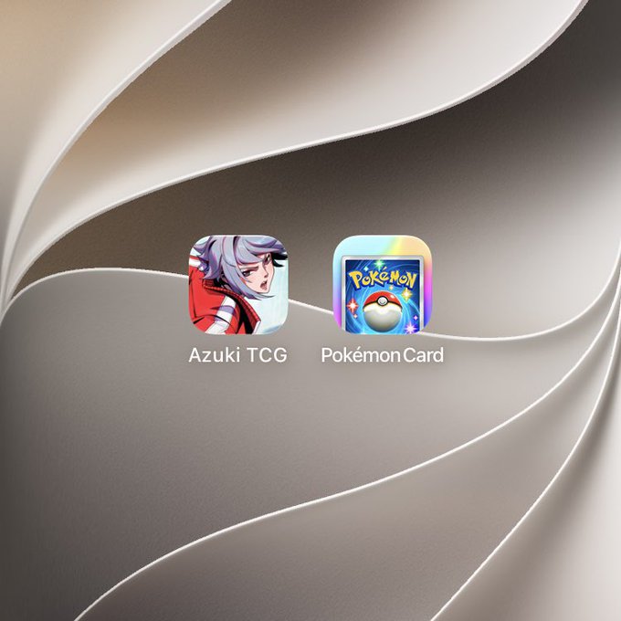 A mobile home screen displaying two app icons side by side: "Azuki TCG" featuring an anime-style character, and "Pokémon Card" showing a Poké Ball.