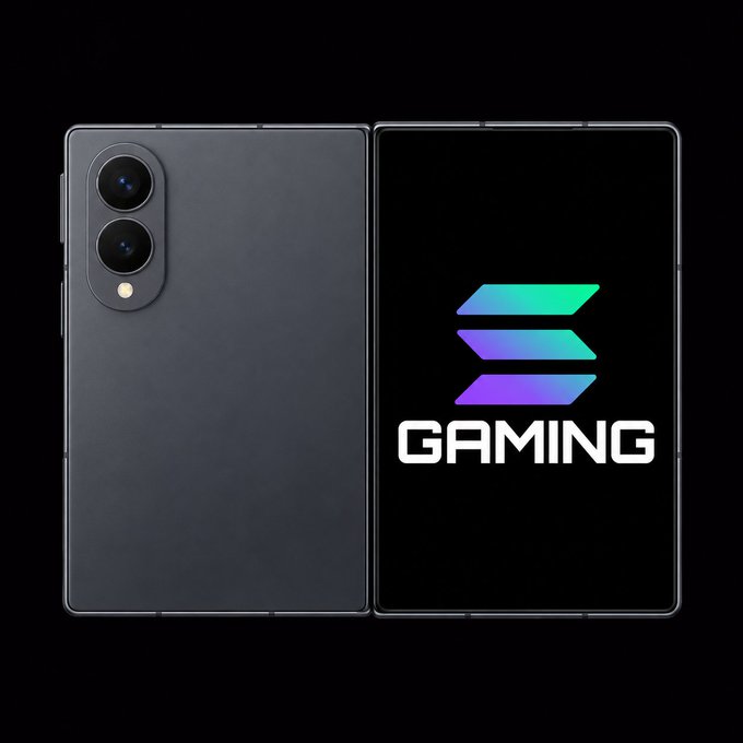 A black Samsung foldable phone displayed open, showing the back panel with dual rear cameras on the left half and a vibrant "GAMING" logo with the Solana emblem on the inner screen. The image visually reinforces the post's message by pairing Solana's branding directly on Samsung hardware to promote mobile gaming on the blockchain.