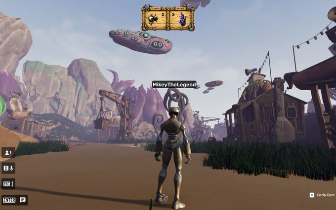 A third-person view of a metallic character named 'MikeyTheLegend' standing in a vibrant cartoonish video game environment with floating airships.
