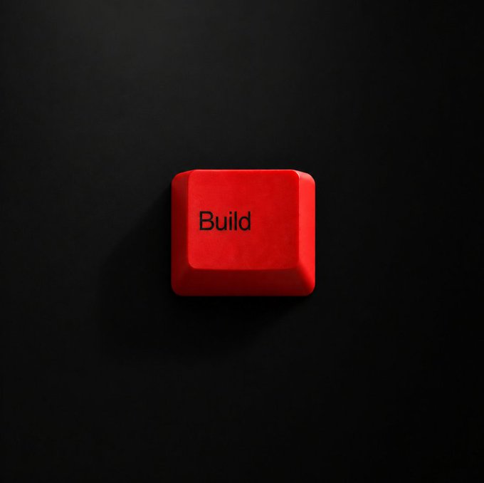 A bright red keycap featuring the word "Build" sits against a dark background, visually echoing the motivational "Keep building on TRON" message by symbolizing the act of constructing and developing. The minimalist design reinforces a call to action for continuous creation and progress.