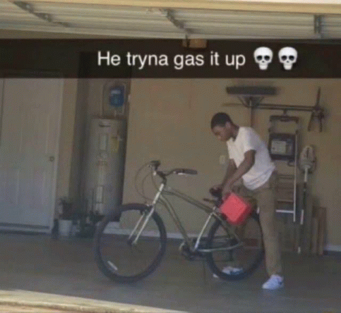 A man in a garage attempts to refuel a bicycle with a red gas can, with the caption 'He tryna gas it up 💀💀'.