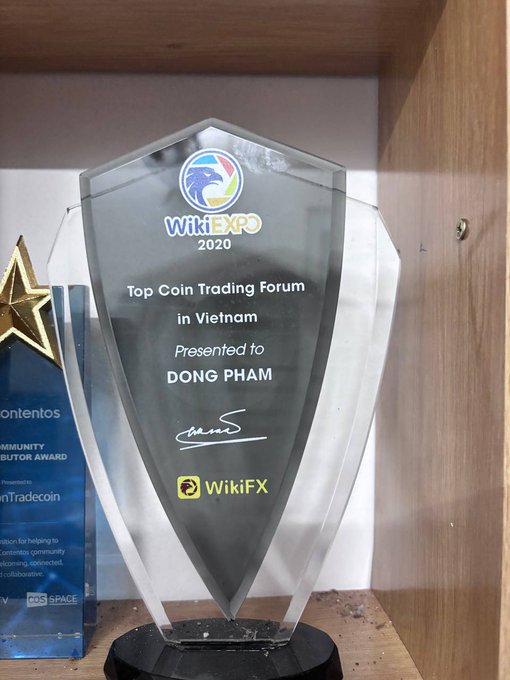 A WikiEXPO 2020 crystal trophy awarded to 'DONG PHAM' as 'Top Coin Trading Forum in Vietnam' with WikiFX logo.
