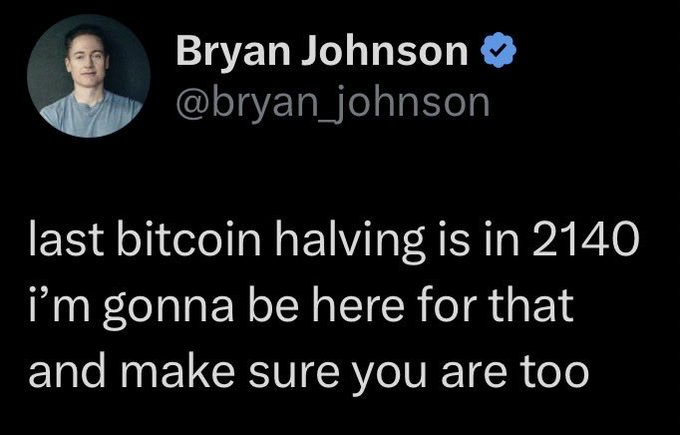 A tweet from Bryan Johnson (@bryan_johnson) reads: "last bitcoin halving is in 2140 i'm gonna be here for that and make sure you are too." The caption humorously relates to the post about a year of BTC exposure, referencing Johnson's anti-aging project "Don't Die" and his ambition to live long enough to witness Bitcoin's final halving.