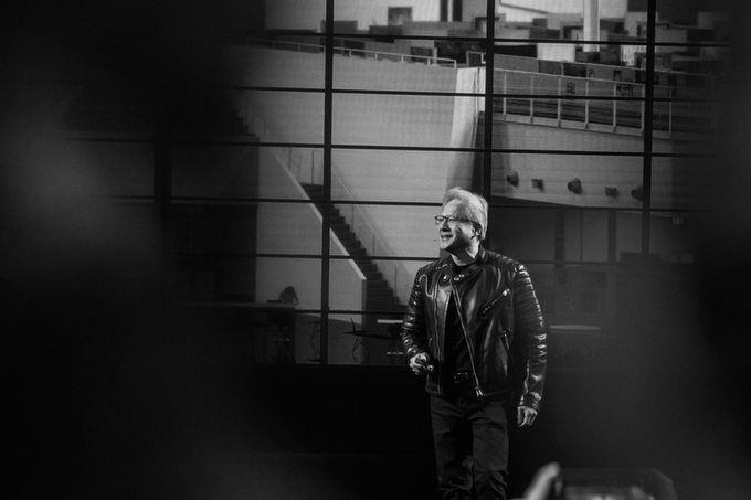 Nvidia CEO Jensen Huang, dressed in his signature black leather jacket, speaks on stage at an event, reinforcing his bullish stance on AI and cybersecurity as the company's next major investment frontier for $NVDA.