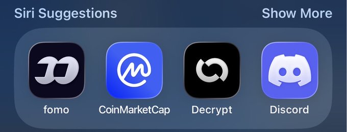 The image shows an iOS Siri Suggestions widget displaying four app icons: Fomo, CoinMarketCap, Decrypt, and Discord, with the Decrypt app prominently featured among the suggestions. This visually supports the post's call to action "Get the Decrypt App now!" by showcasing Decrypt as a recommended app alongside other popular crypto-related and communication apps.