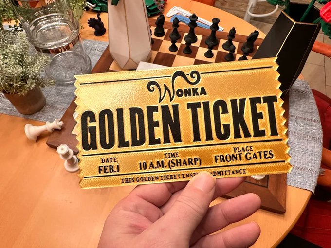 A hand holds a golden 'WONKA GOLDEN TICKET' displaying 'DATE: FEB.1', 'TIME: 10 A.M. (SHARP)', and 'PLACE: FRONT GATES', with a wooden chessboard behind it.