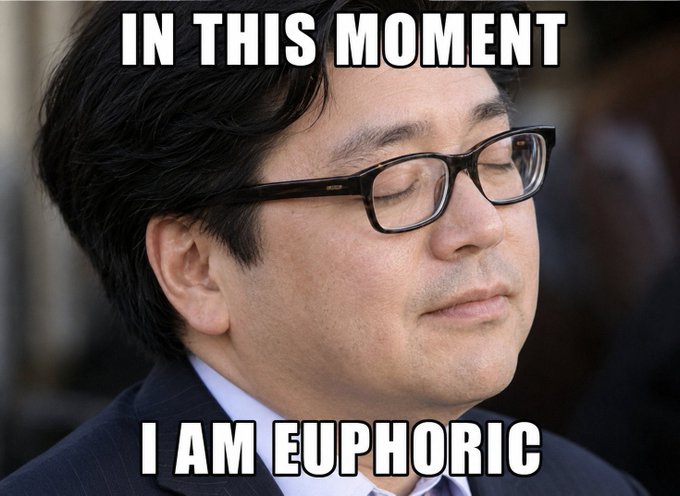 A man with glasses appears serene and meditative with his eyes closed, paired with the meme text "IN THIS MOMENT I AM EUPHORIC" — humorously capturing the calm-before-the-storm vibe as BitMine (BMNR) aggressively stacks ETH while their CFO Young Kim publicly downplays the pace of buying.