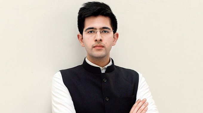 A young man with glasses stands with arms crossed, wearing a white shirt under a dark vest, against a plain white background. His confident, composed expression suggests he's unfazed by the Bitcoin price already hitting $125k.